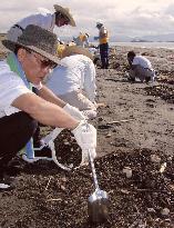 Kagoshima residents remove heavy oil from shore